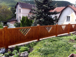 Dřevěné plotové sloupky nasazeny na kovové tyče původního plotu.