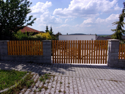 Dřevěný plot z plotových planěk zakončených úkosem